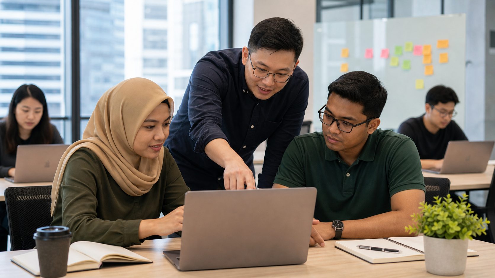 Singaporean instructor guiding Chinese, Malay and Indian learners in a hands-on AI agents workshop